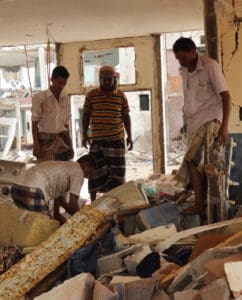 Men dig through rubble in a residential compound housing employees of the Mokha Steam Power Plant and their families following an airstrike by the Saudi-led coalition that killed at least 65 civilians in Mokha, Yemen on July 24, 2015. (© Ole Solvang/Human Rights Watch)